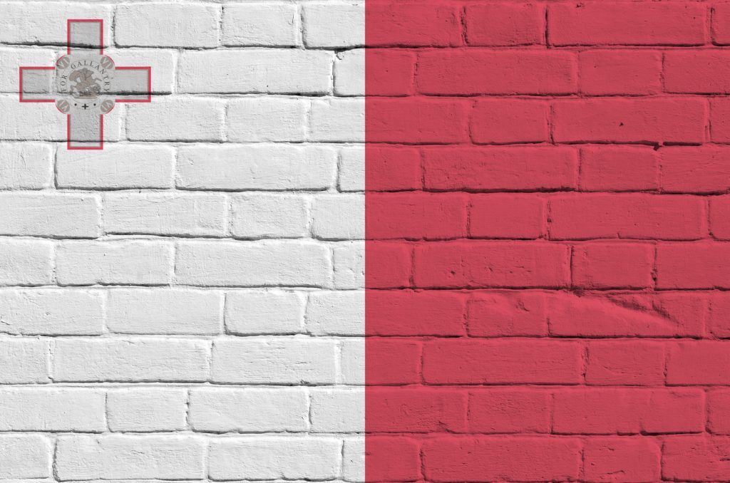 Malta flag depicted in paint colors on old brick wall close up